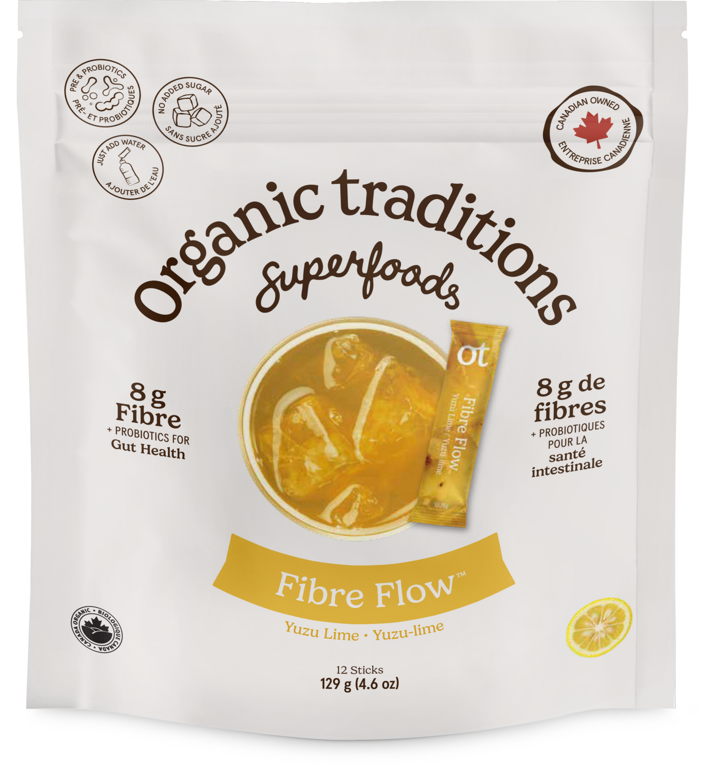 A white stand-up pouch of Organic Traditions Superfoods Fibre Flow yuzu lime snack sticks, featuring a yellow-orange bowl graphic of the snack sticks in a drink, a yellow lemon slice illustration, and text detailing 8g of fibre.