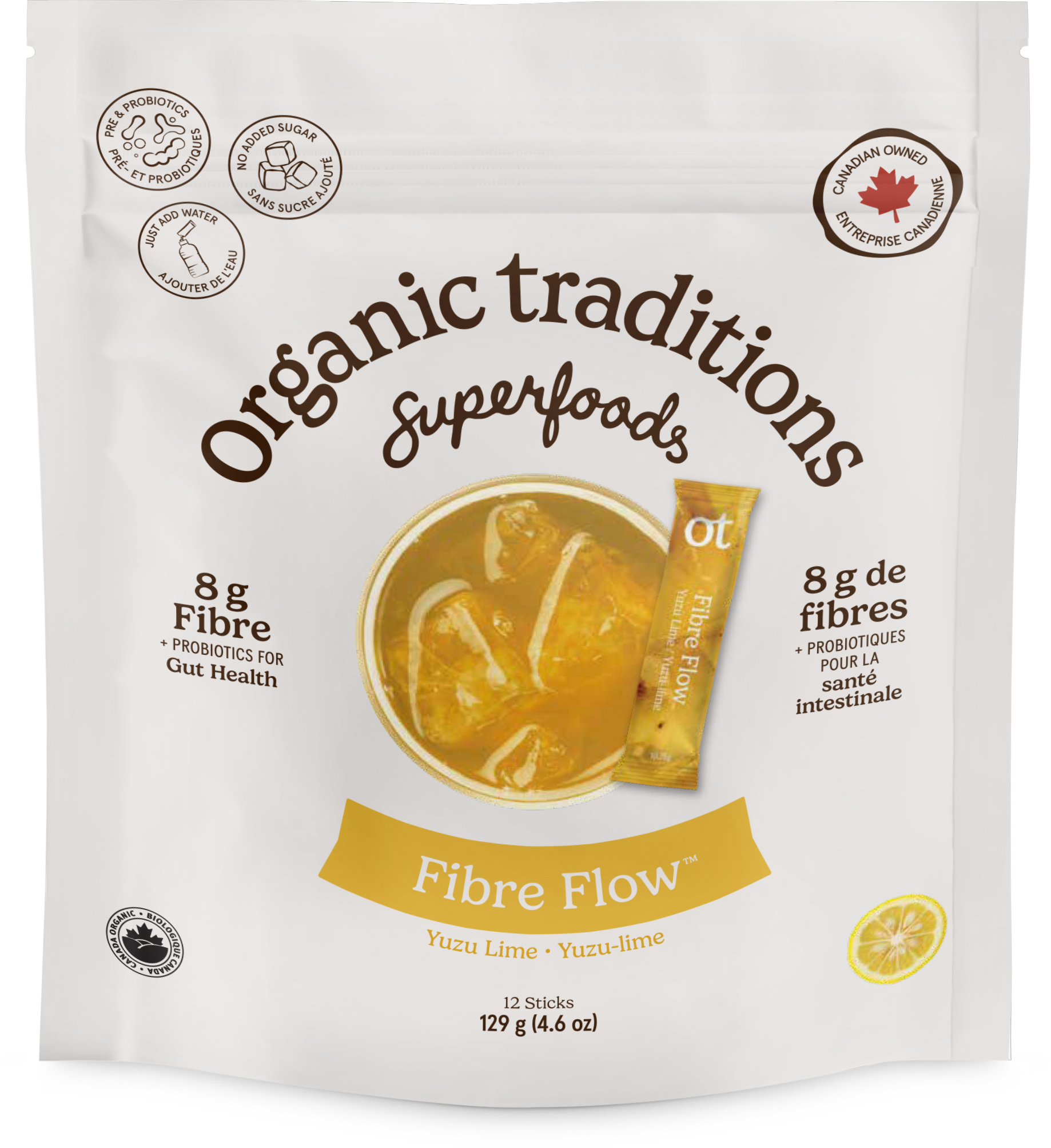 A white stand-up pouch of Organic Traditions Superfoods Fibre Flow yuzu lime snack sticks, featuring a yellow-orange bowl graphic of the snack sticks in a drink, a yellow lemon slice illustration, and text detailing 8g of fibre.